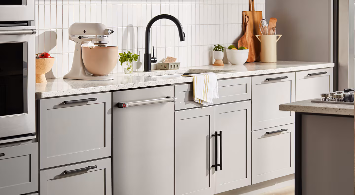 KitchenAid® flush dishwasher among light gray kitchen cabinetry